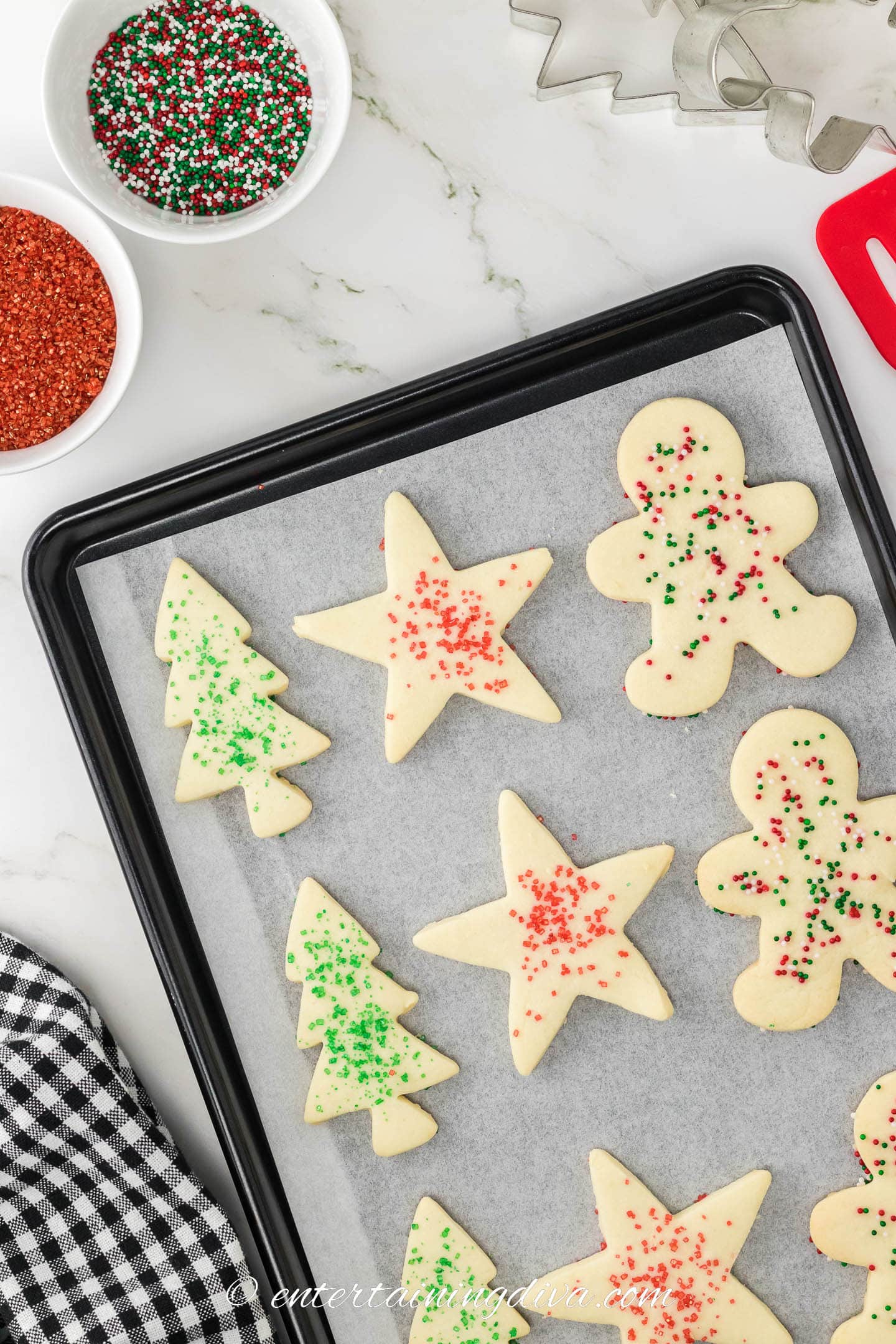 baked cut out shortbread cookies with sprinkles on a baking sheet