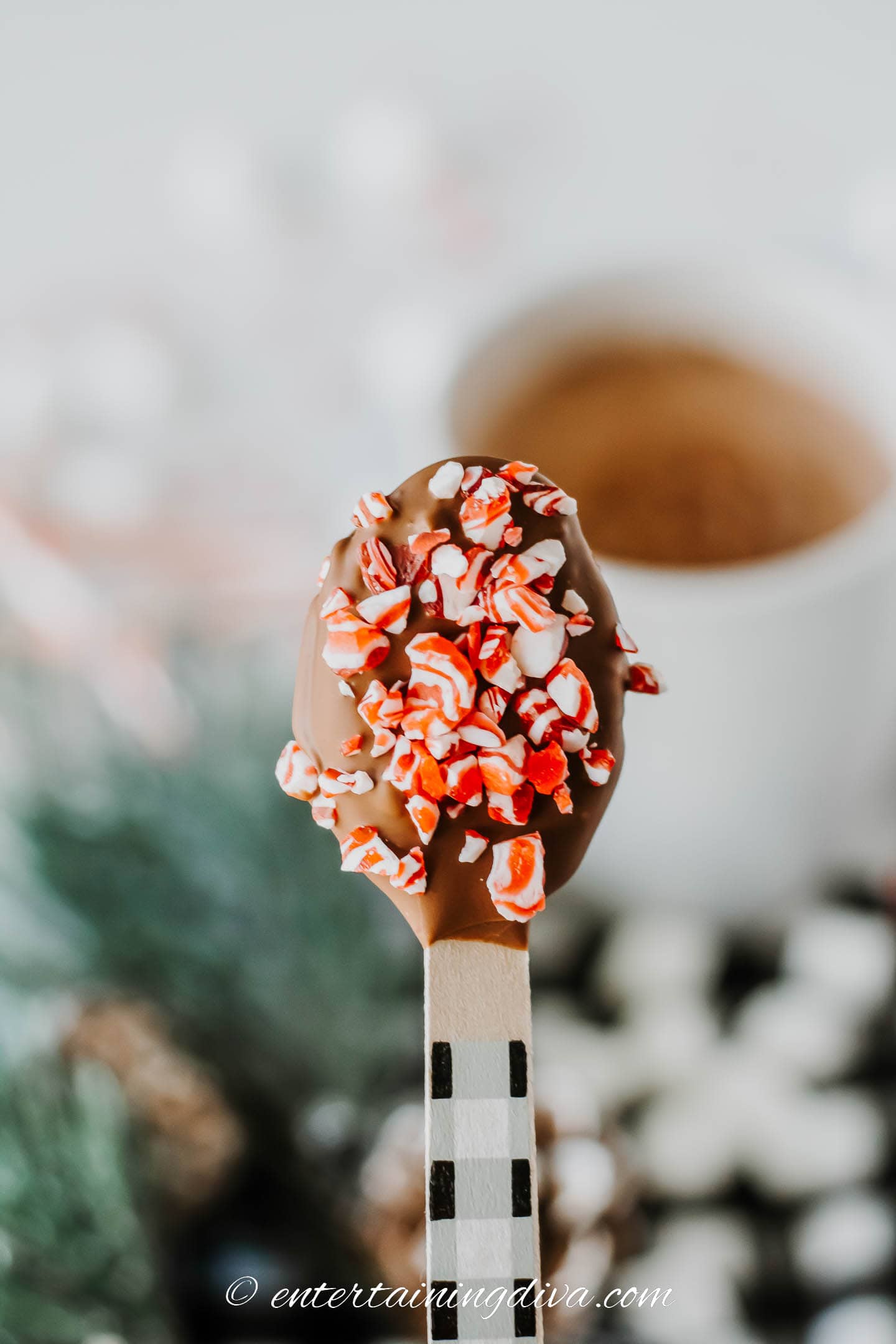 hot chocolate dunking spoon covered with crushed candy canes