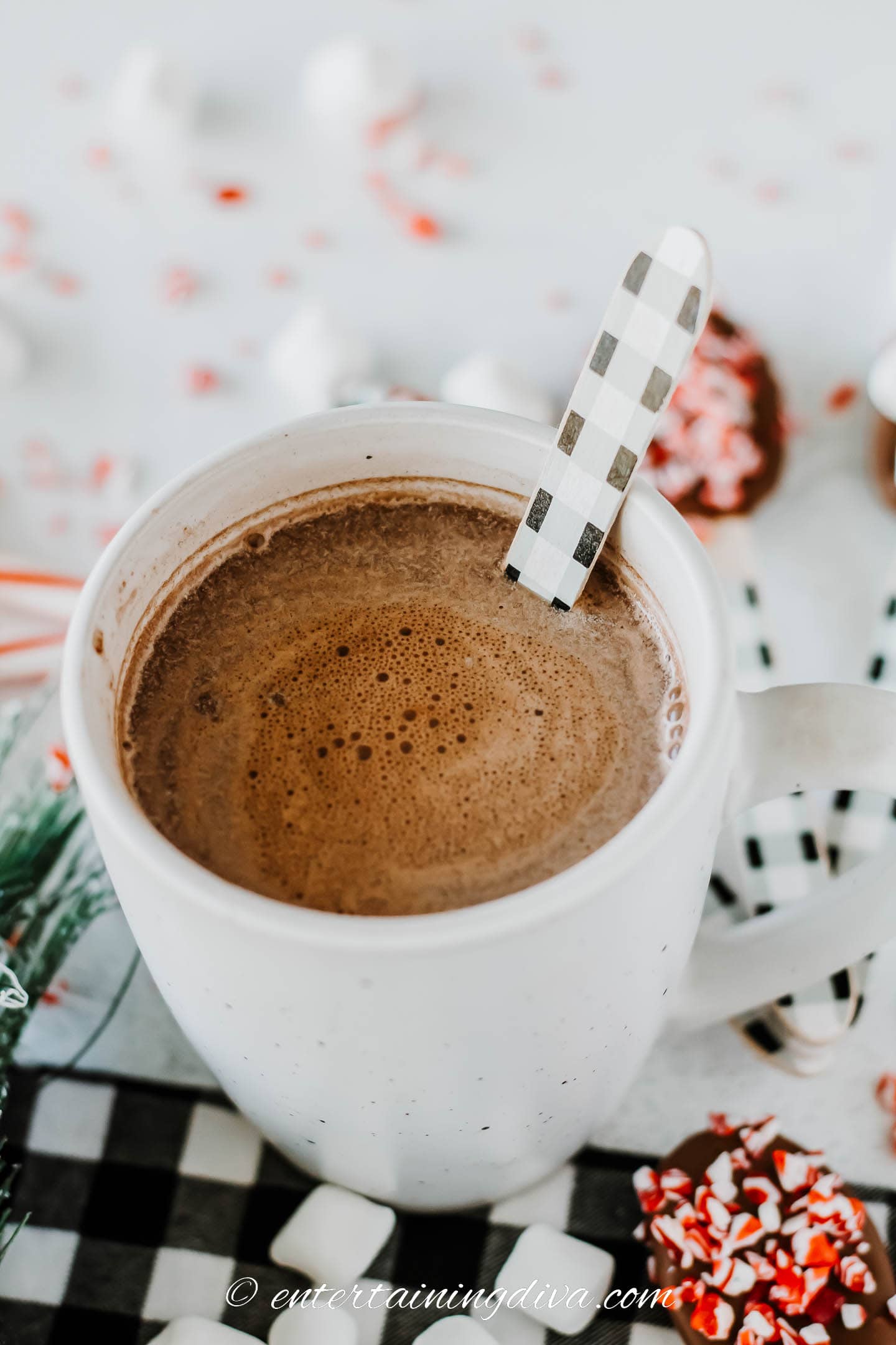 homemade hot chocolate stirring spoon in a cup of hot cocoa