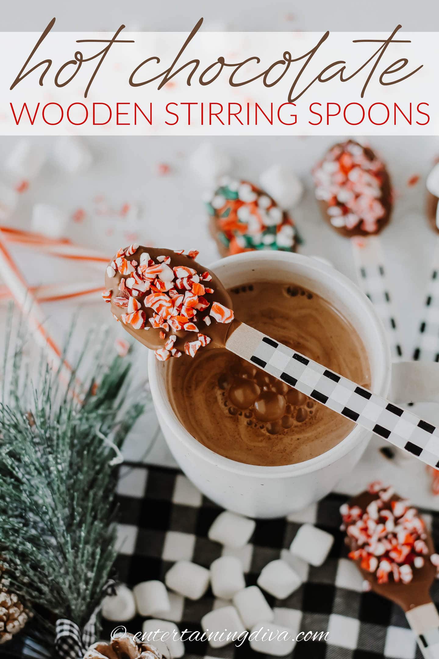 DIY hot chocolate wooden stirring spoon on top of a mug of hot cocoa