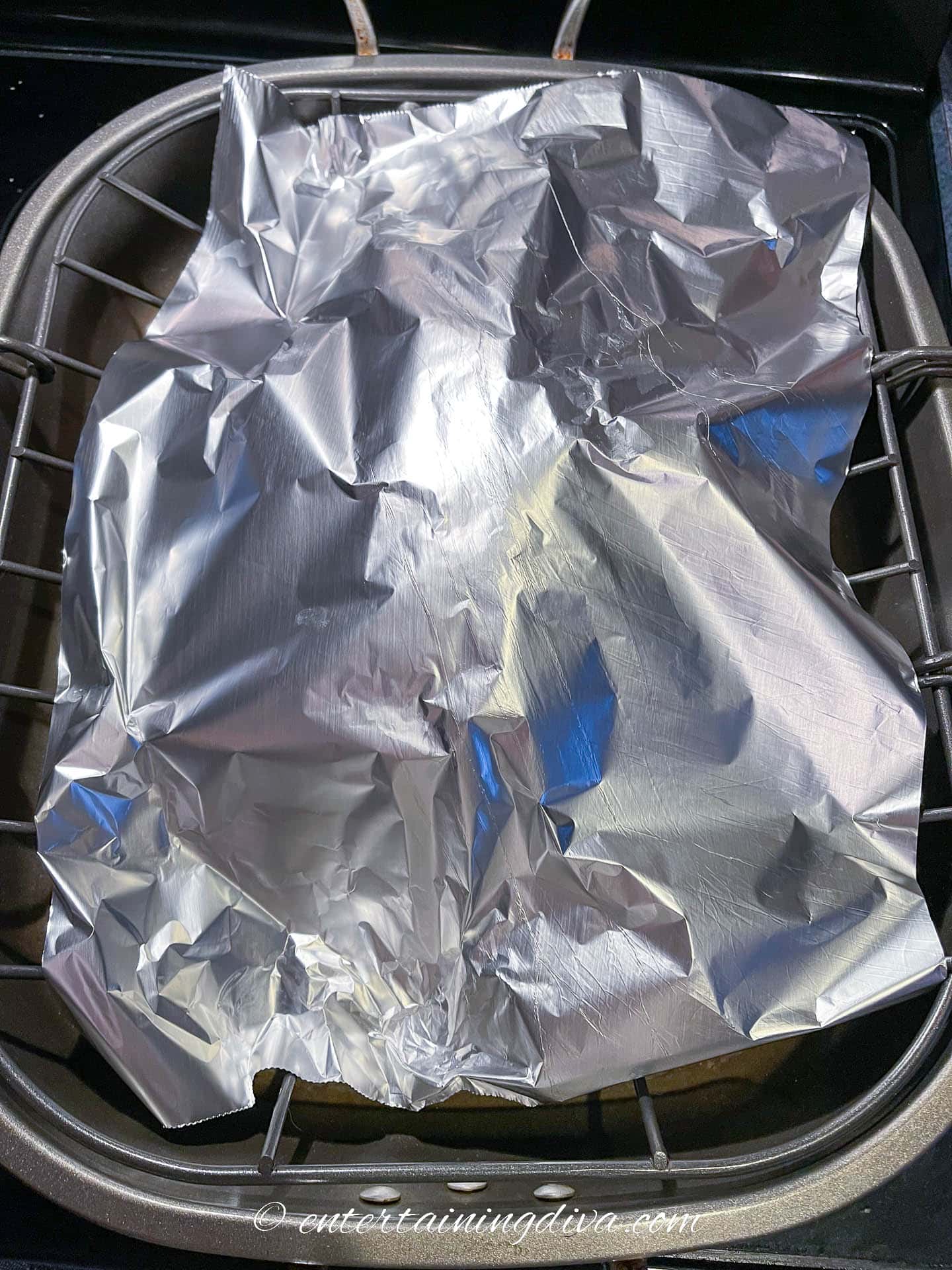Turkey in a roasting pan covered with foil