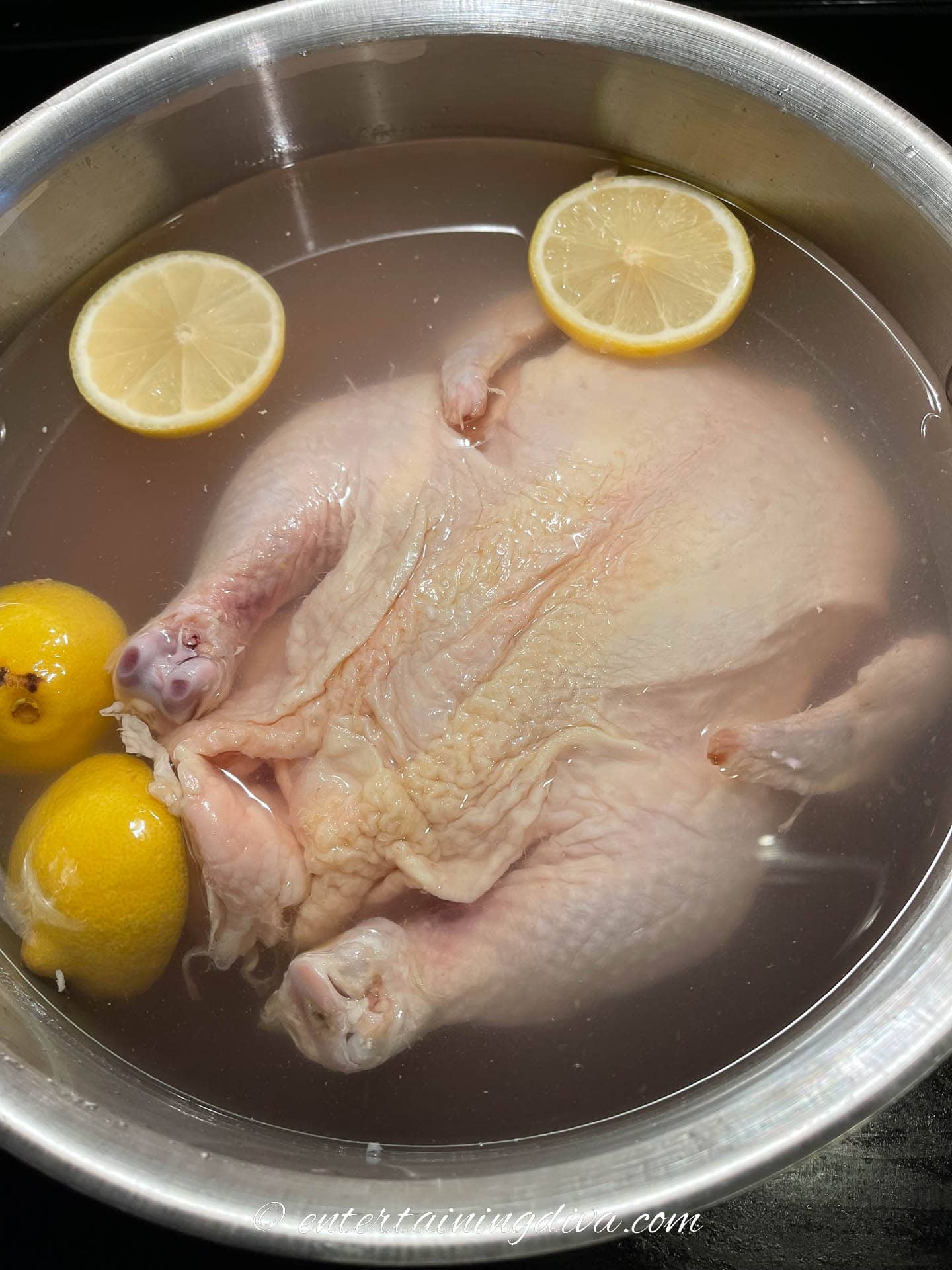 Turkey brining in a pot with lemons