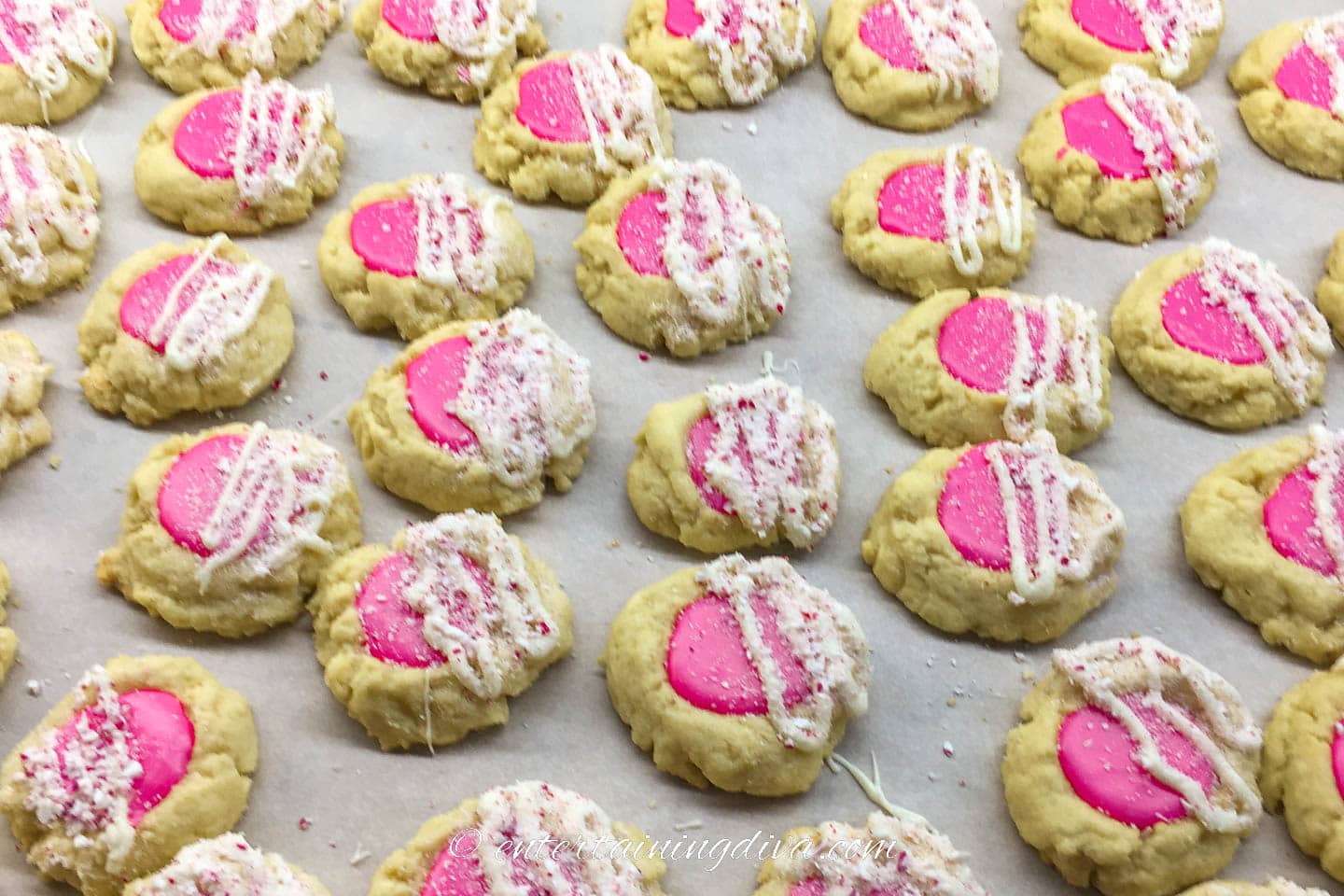 thumbprint cookies garnished with white chocolate and crushed candy canes