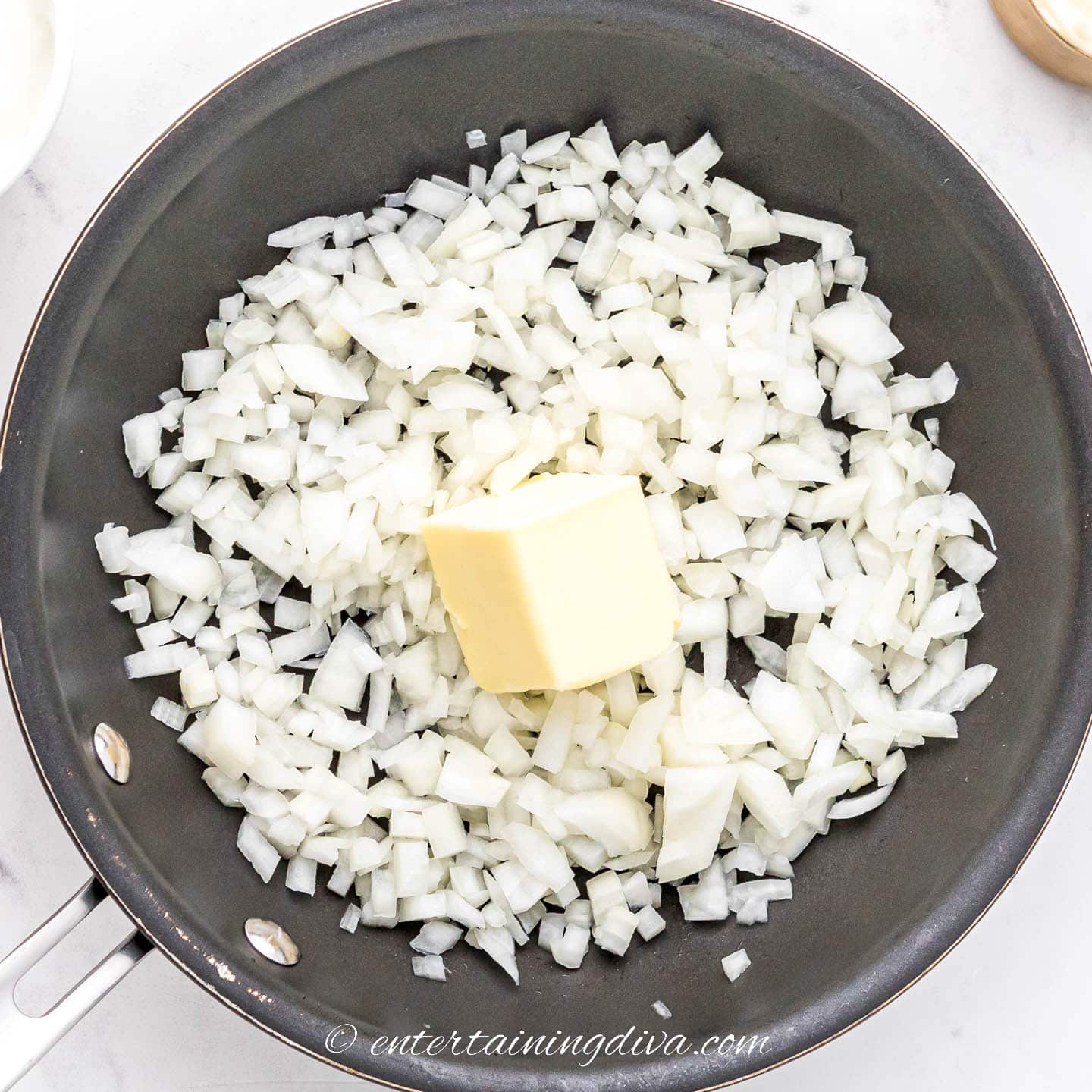 Chopped onions with butter in a frying pan