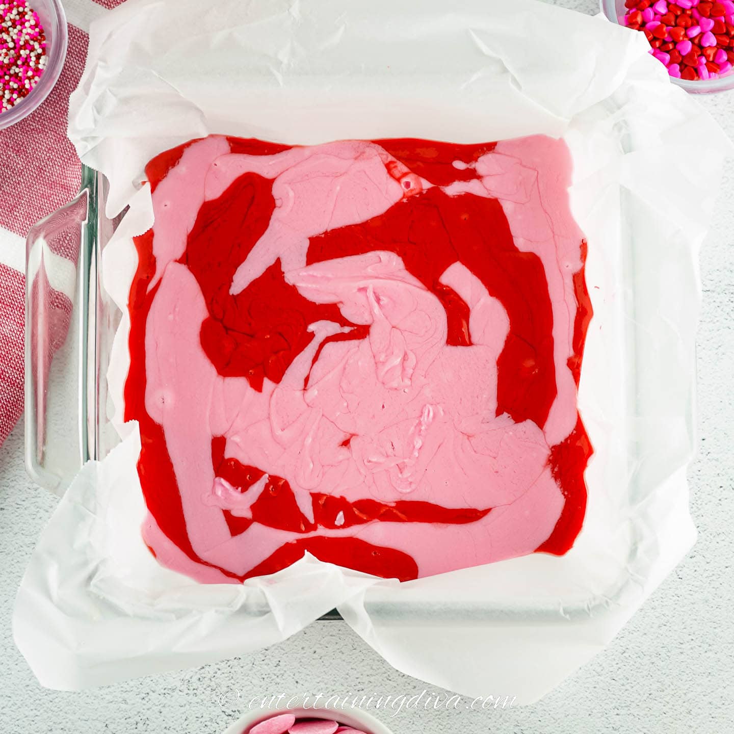 Red and pink strawberry swirl fudge in the pan before chilling