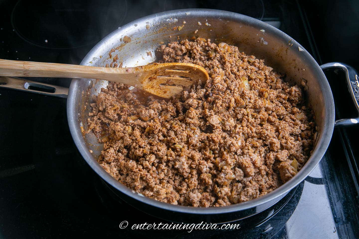 ground turkey with onion, chili powder and salt in a frying pan