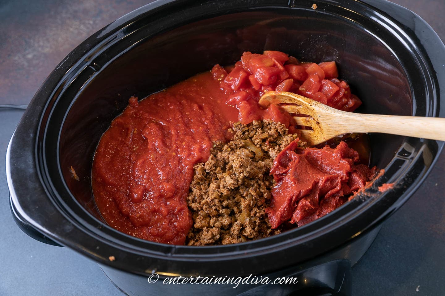 slow cooker with ground turkey mixture, tomatoes and tomato paste