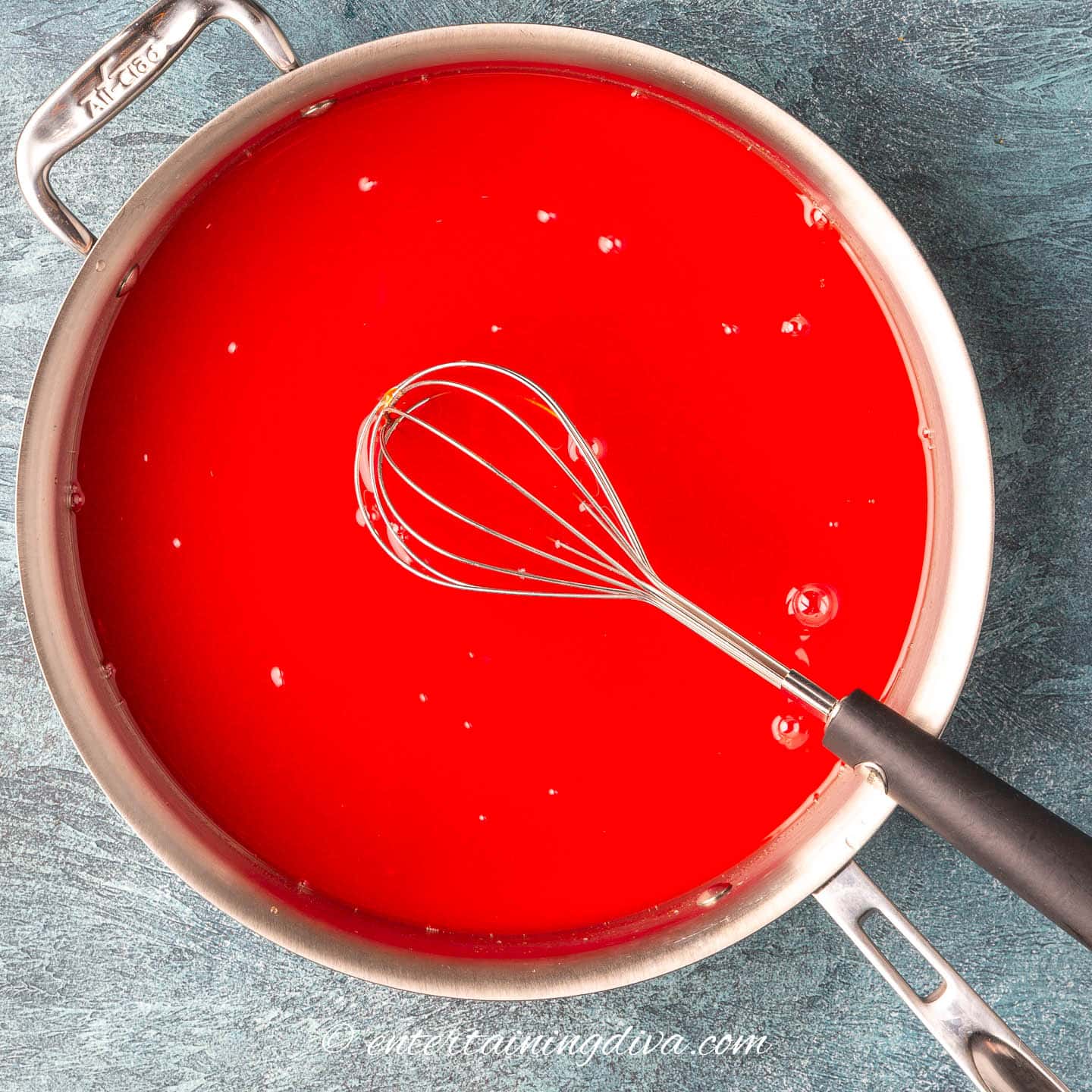 Sweet and sour sauce with corn starch being whisked in
