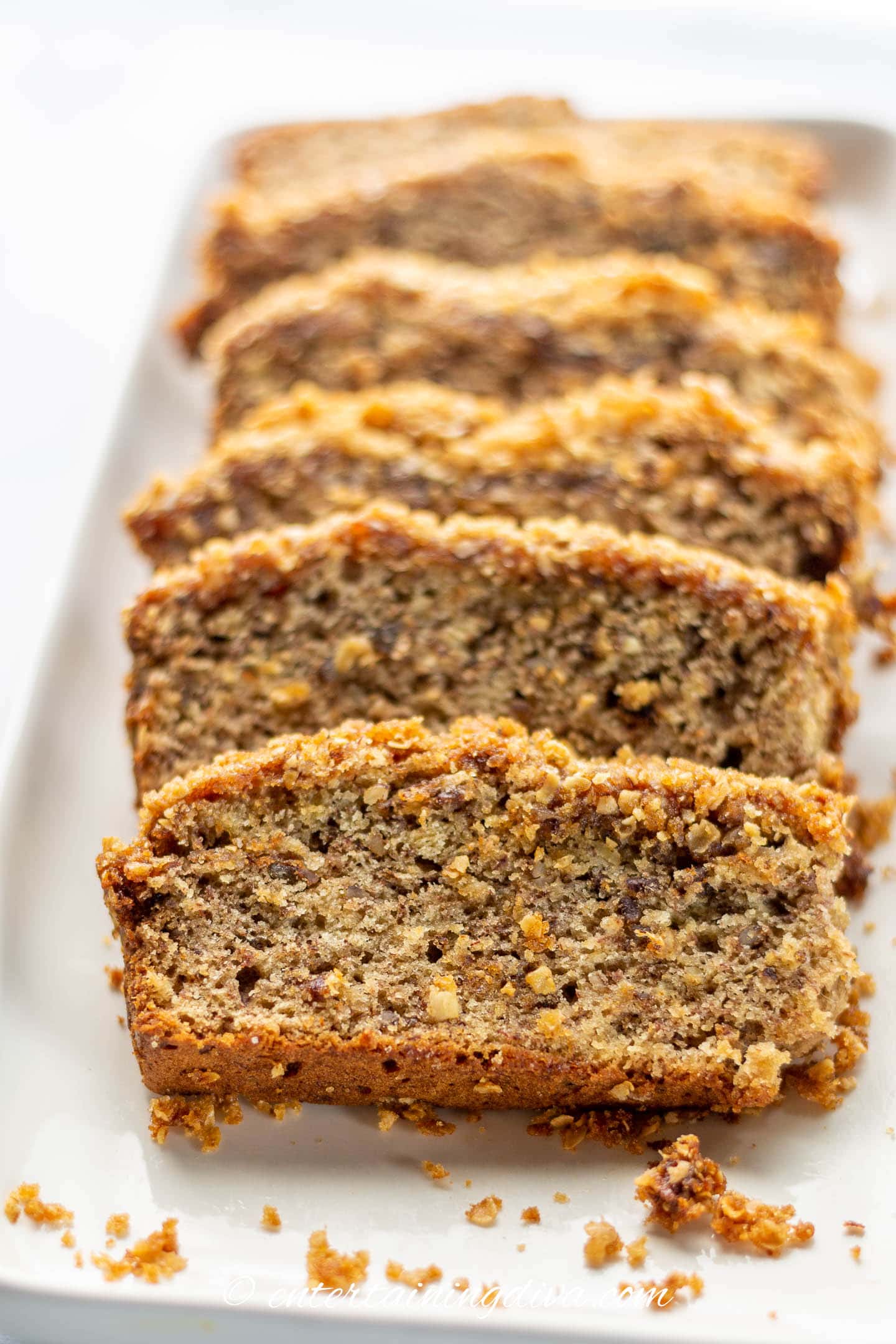 slices of banana nut bread with streusel topping on a plate