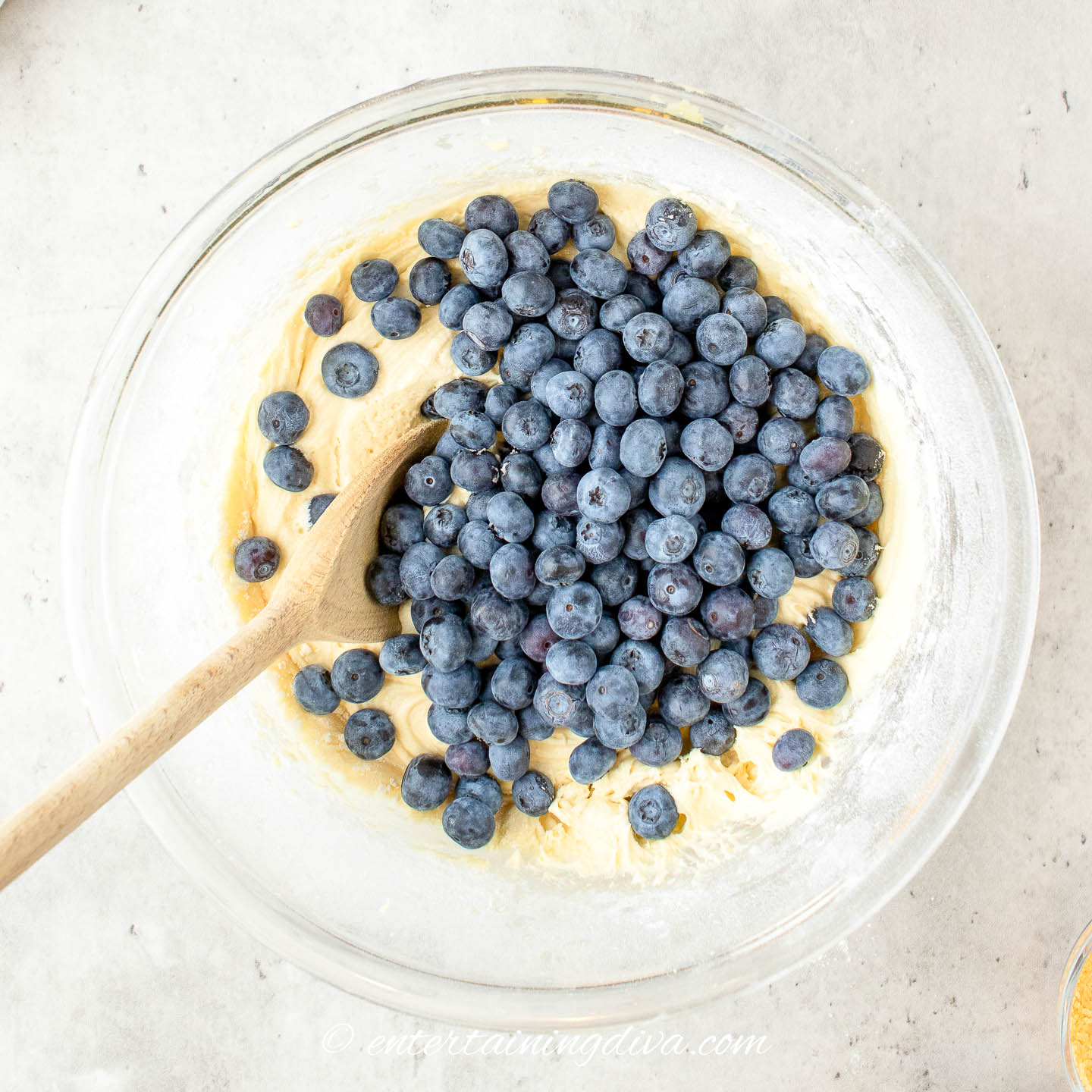 muffin batter with blueberries in a bowl