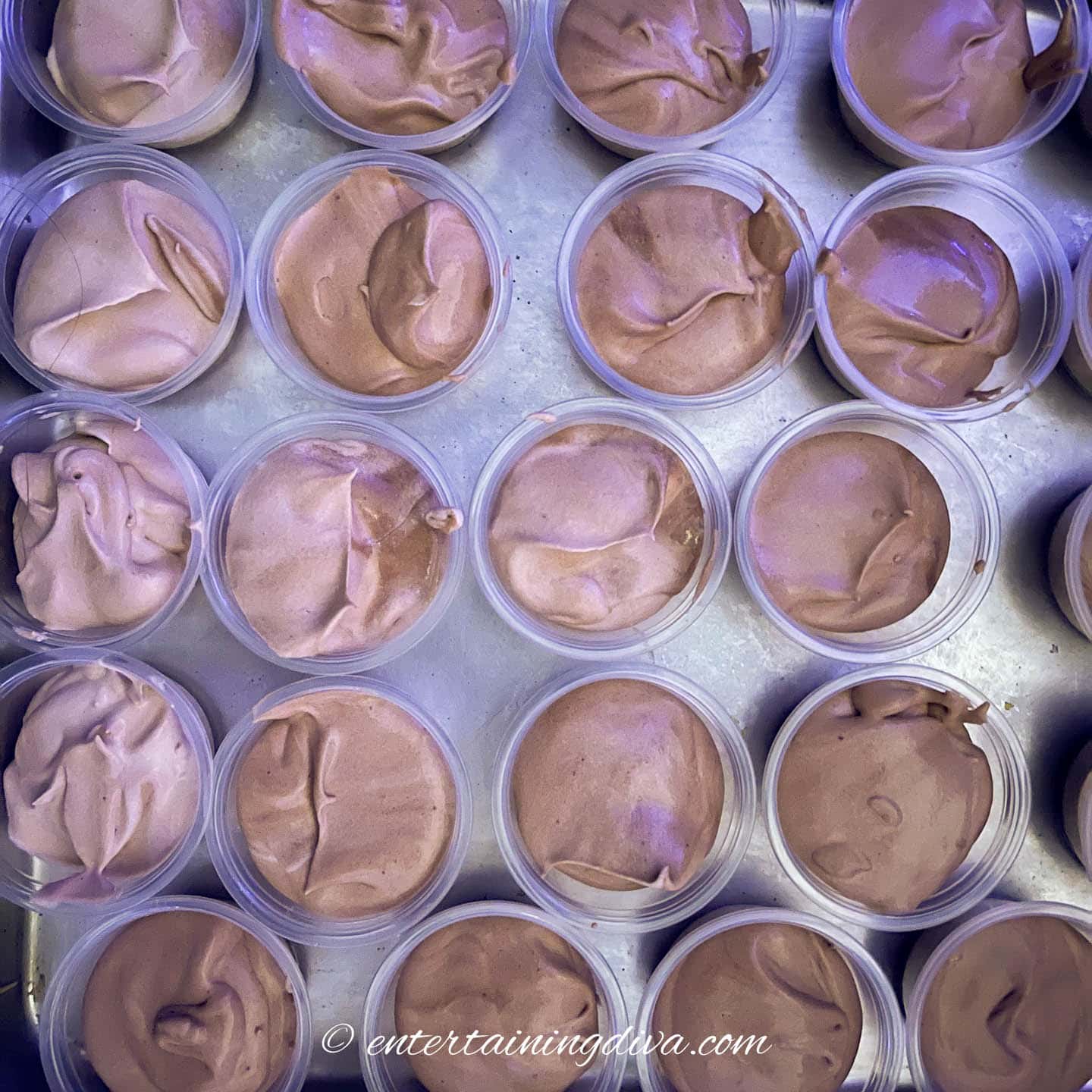 peanut butter chocolate pudding shots in shot cups on a baking tray