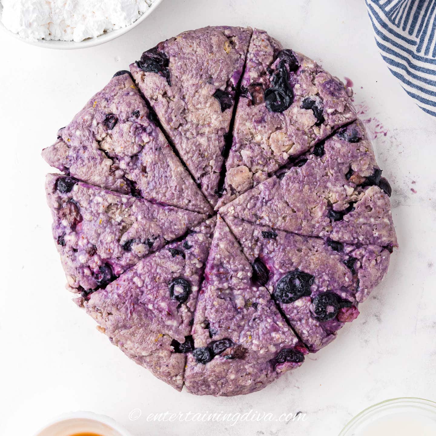 lemon blueberry scone dough pressed into a circle and cut into 8 pieces