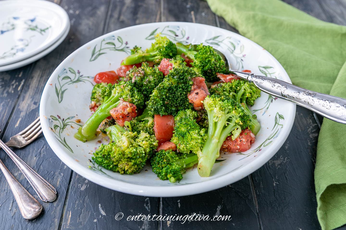 microwaved broccoli with tomatoes and spices on a table ready to be served
