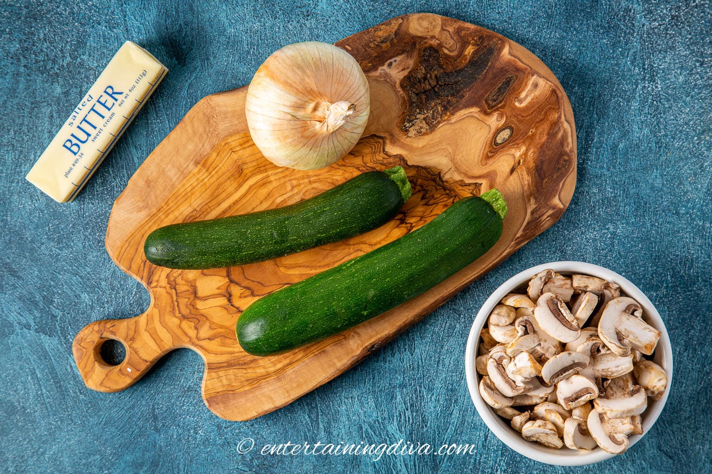 stir fry ingredients - butter, onion, zucchini and mushrooms
