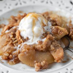 apple crisp with ice cream on a white plate