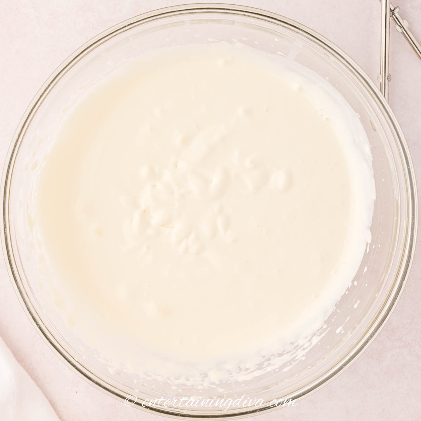 Whipping cream in a mixing bowl