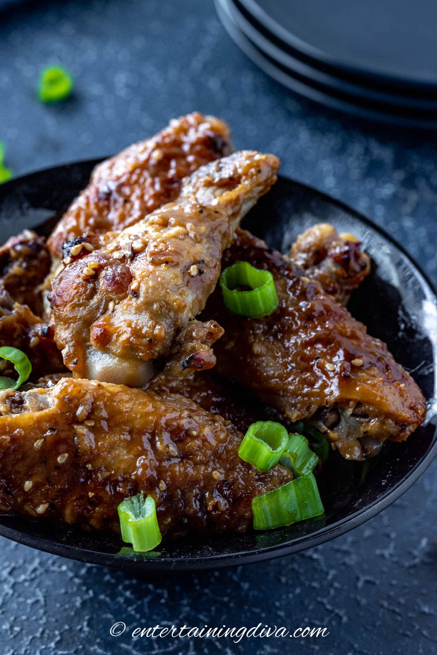 oyster sauce baked wings topped with sesame seeds and green onions