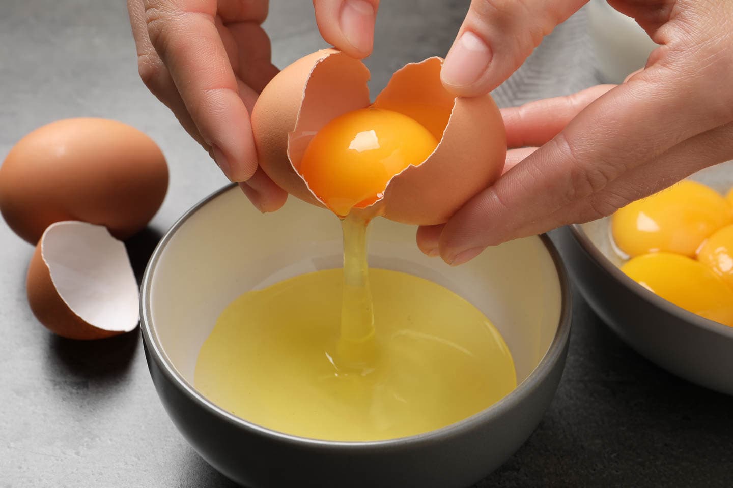 Egg being separated between two egg shells
