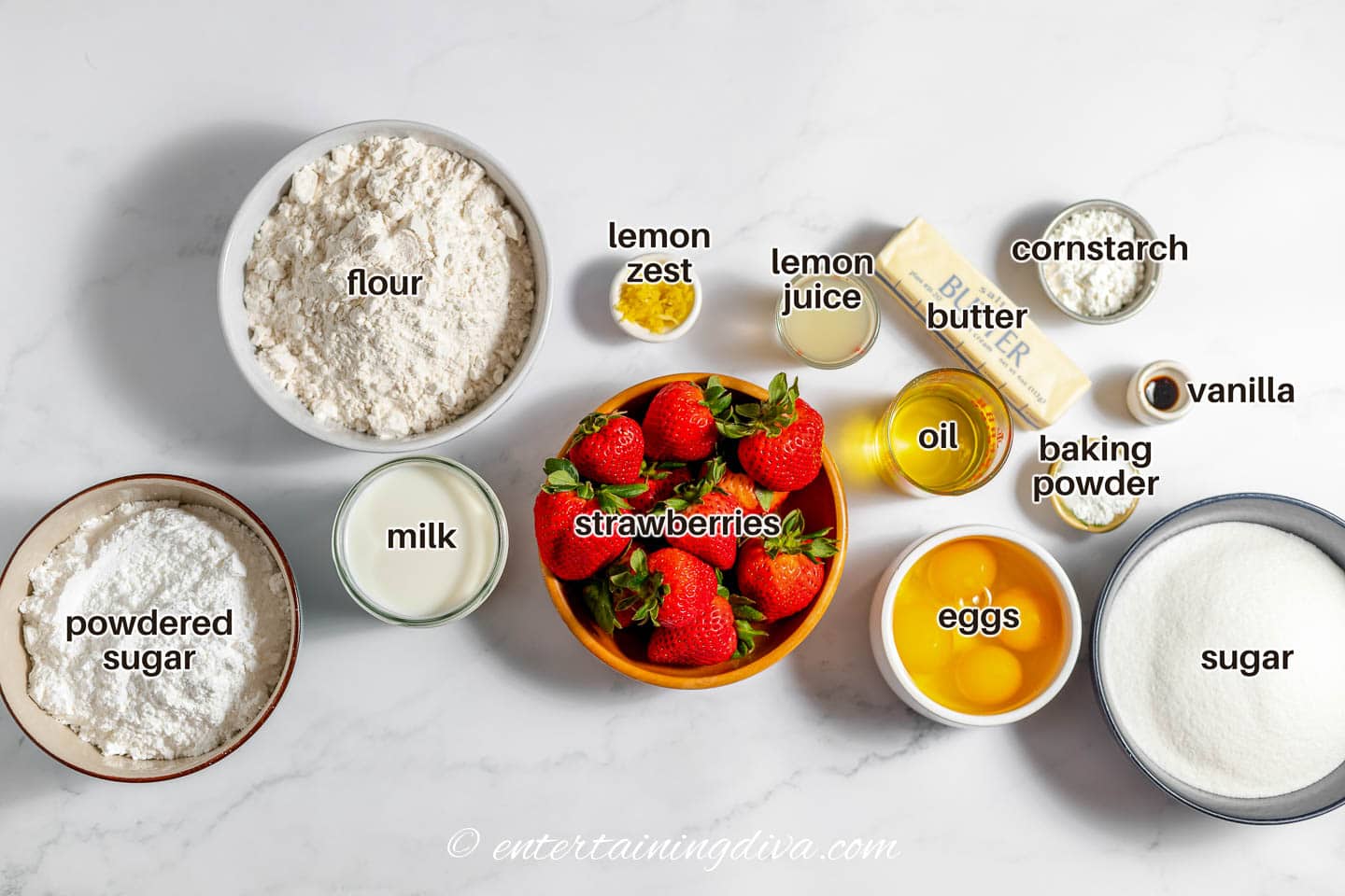 strawberry lemon cake ingredients - strawberries, lemon, oil, flour, milk, sugar, eggs, baking powder, butter, cornstarch, vanilla and powdered sugar