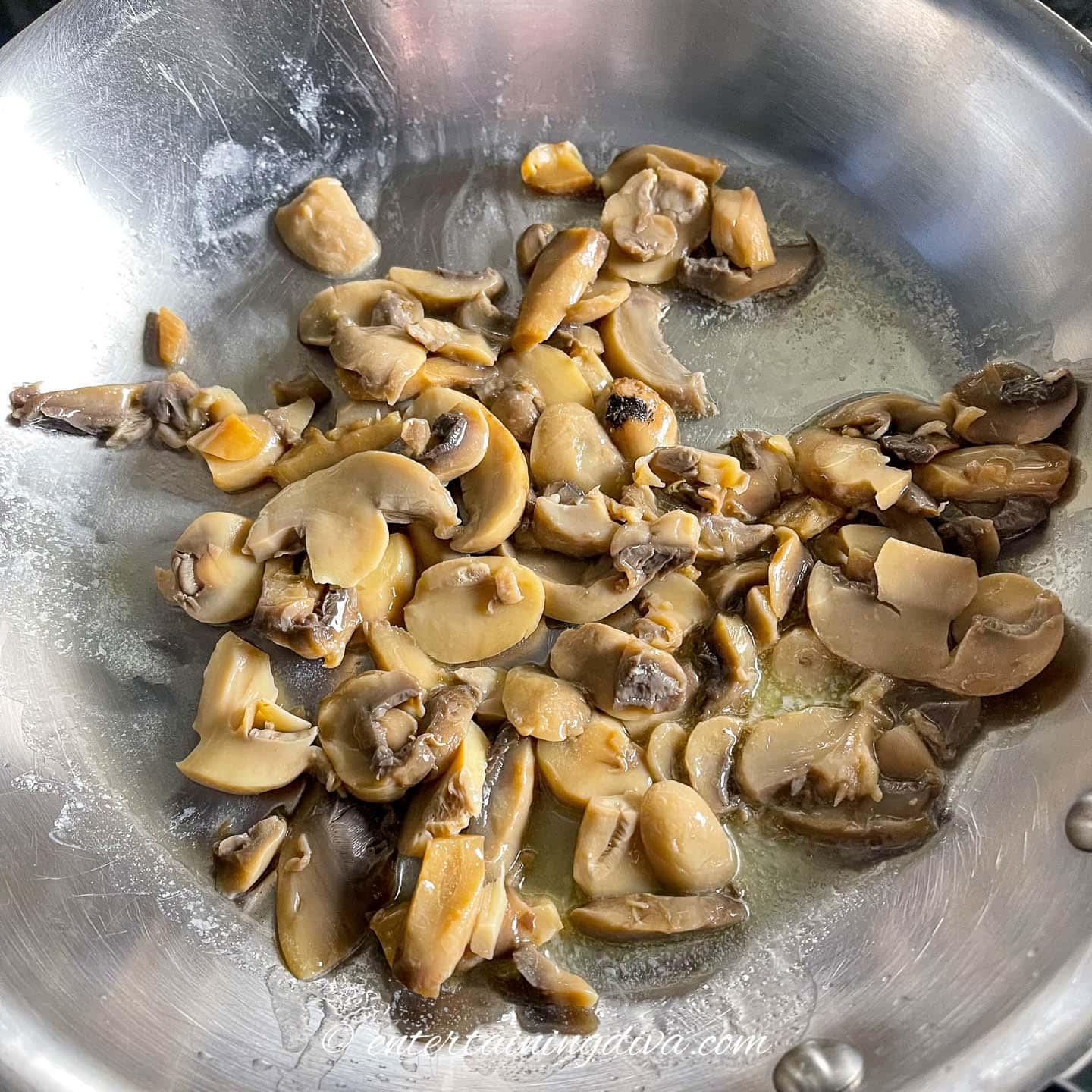 Mushrooms being sauteed in a frying pan
