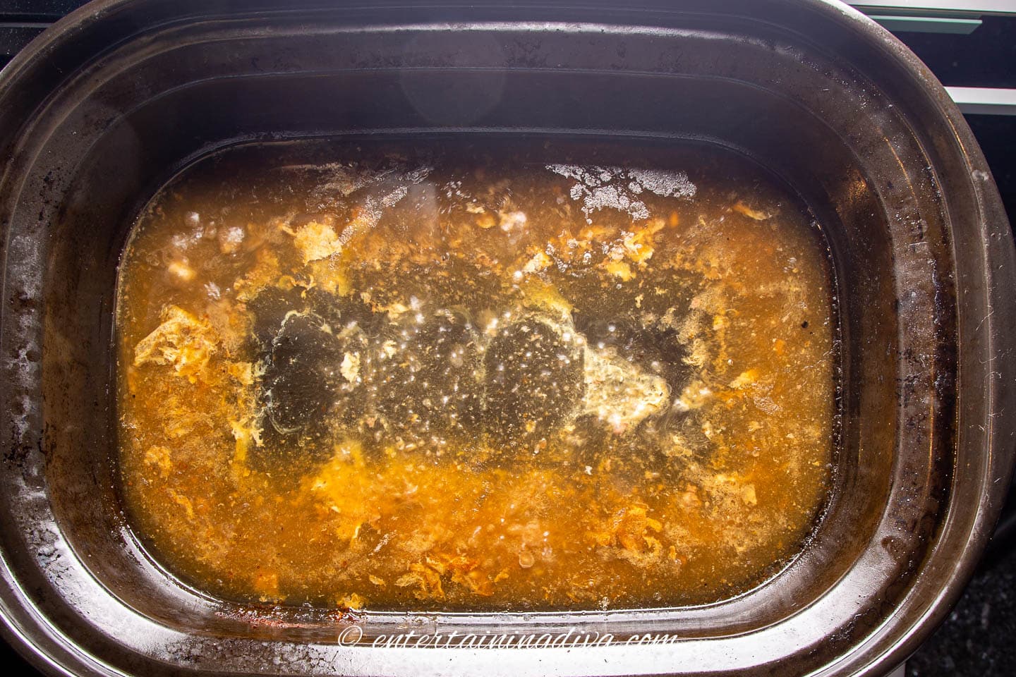 turkey drippings in a roasting pan