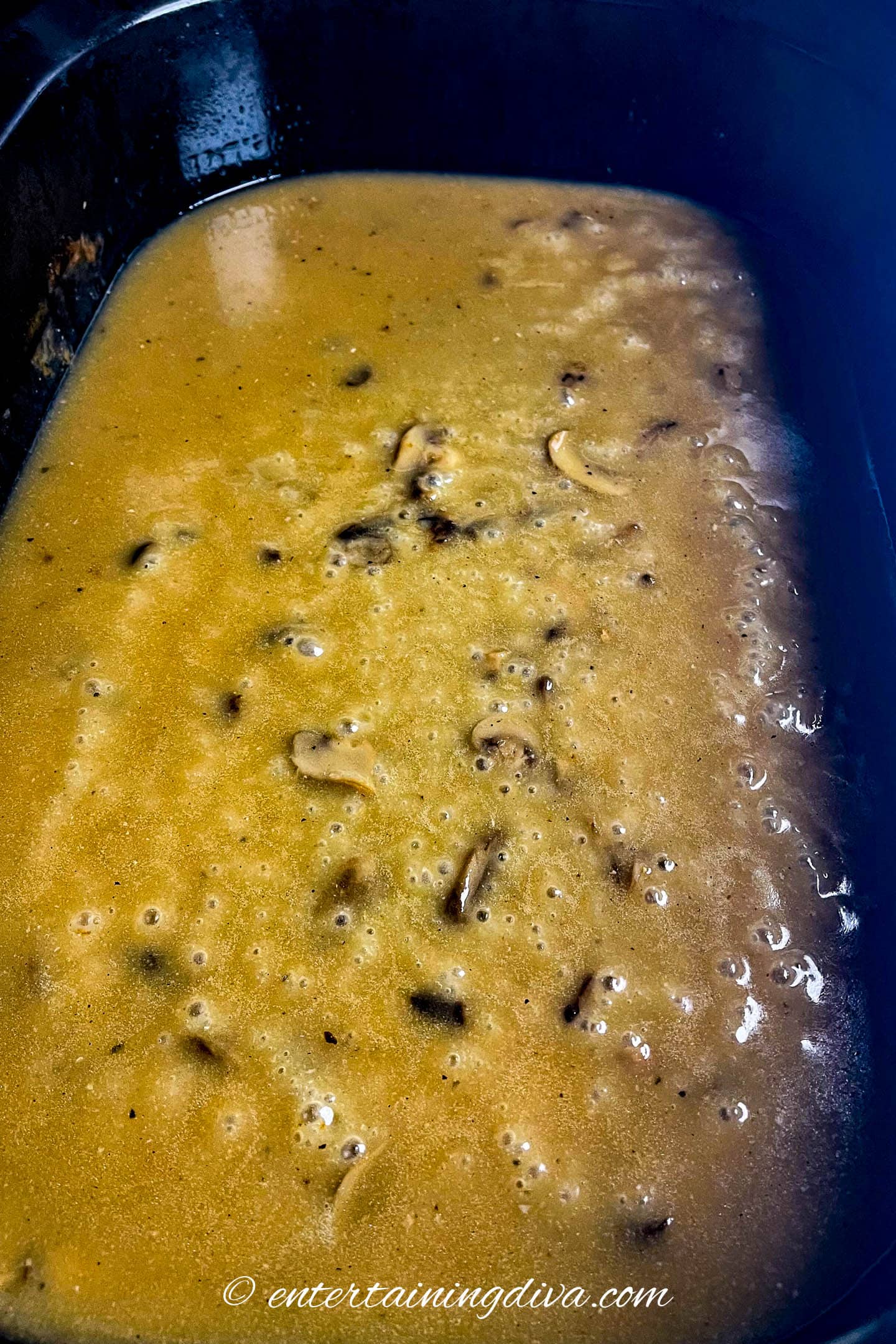 Mushrooms and giblets in turkey gravy in a roasting pan
