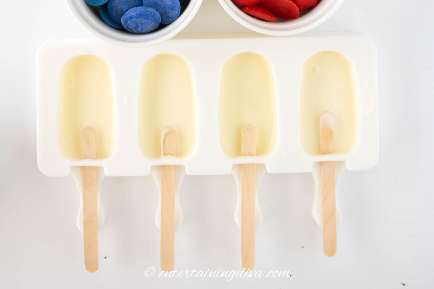 White chocolate in cakesicle molds with popsicle sticks