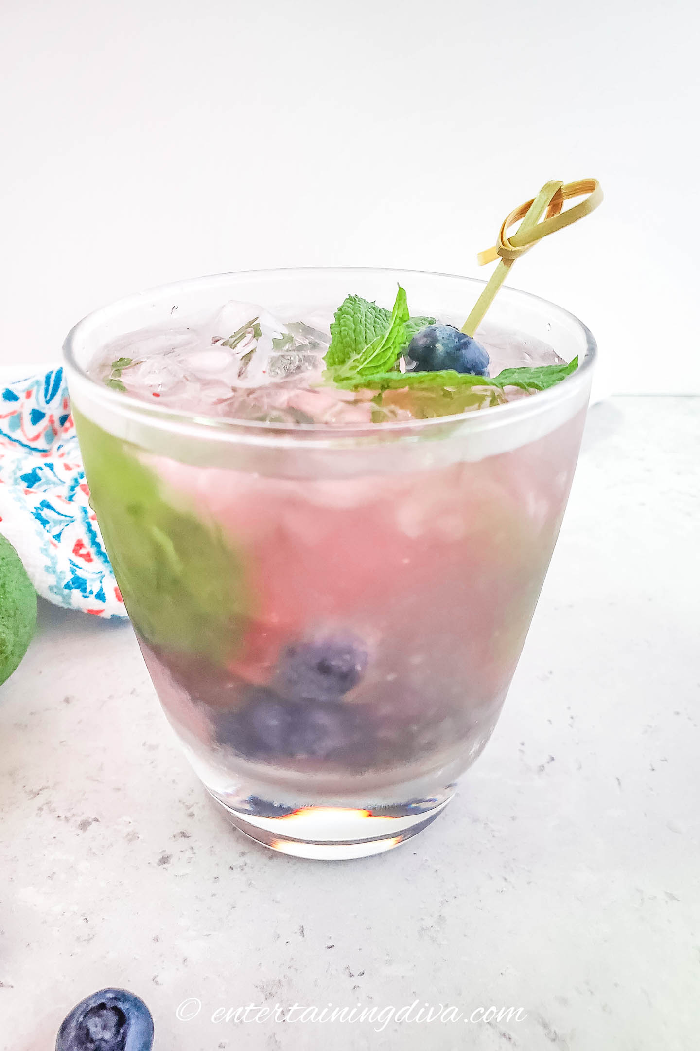 Fresh blueberry mojito with a blueberry and mint garnish