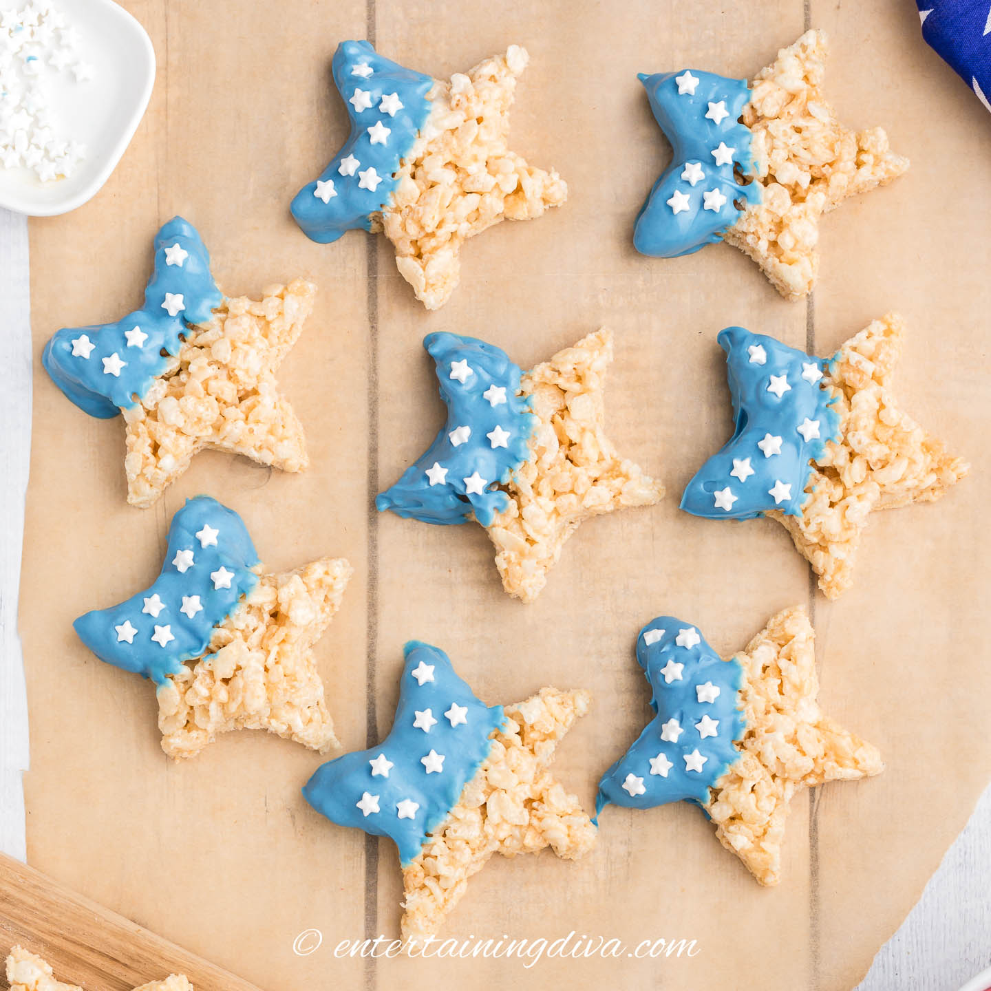 Star shaped rice krispie treats dipped in melted blue candy and sprinkled with white stars