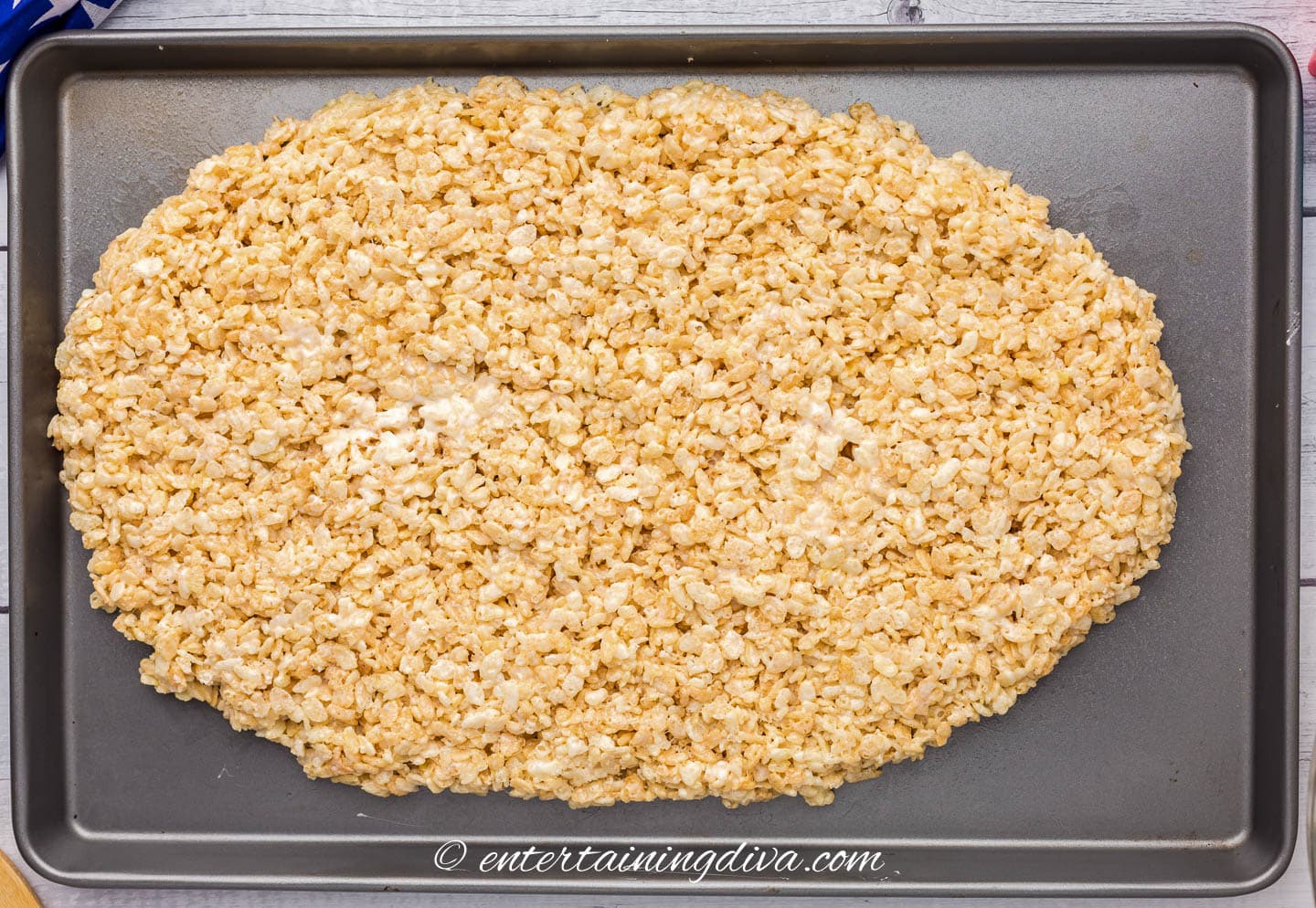 rice krispie mixture spread out on a baking sheet