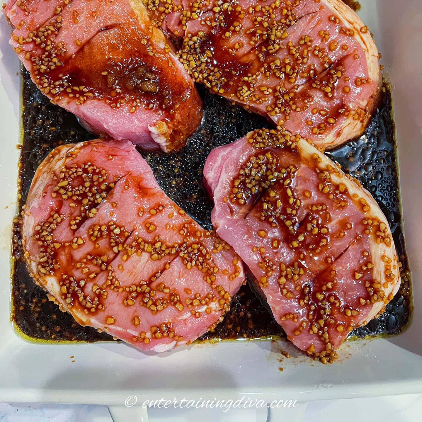 Thick cut pork chops covered in marinade