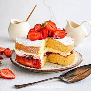 strawberry shortcake cake with a slice out of it