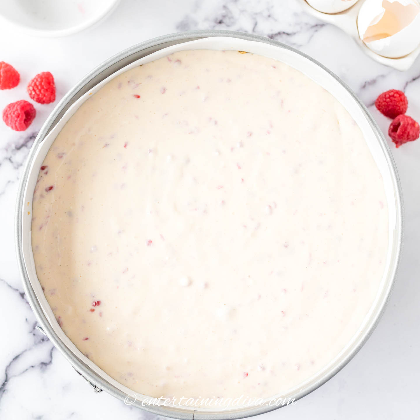 raspberry cheesecake batter in a springform pan before baking