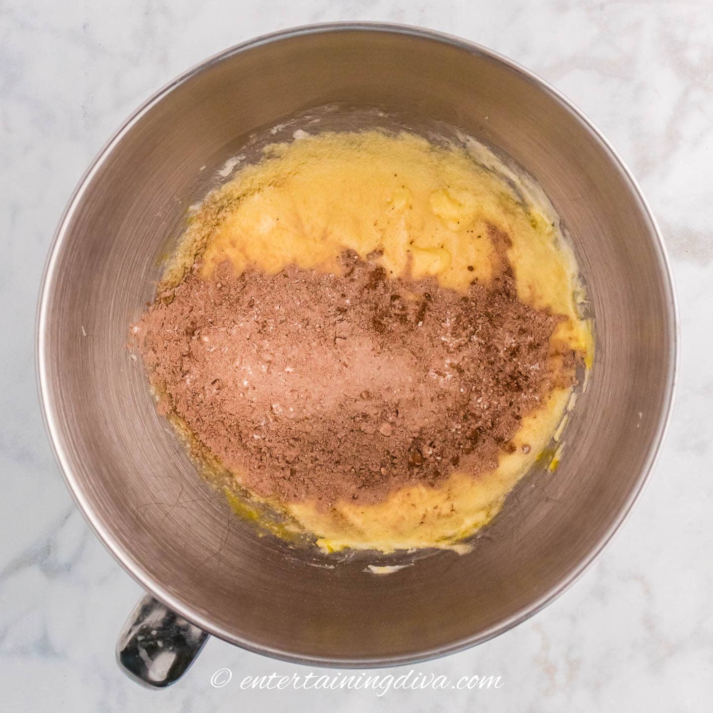 add together the dry ingredients of the chocolate zucchini bread to the butter mixture in a mixing bowl