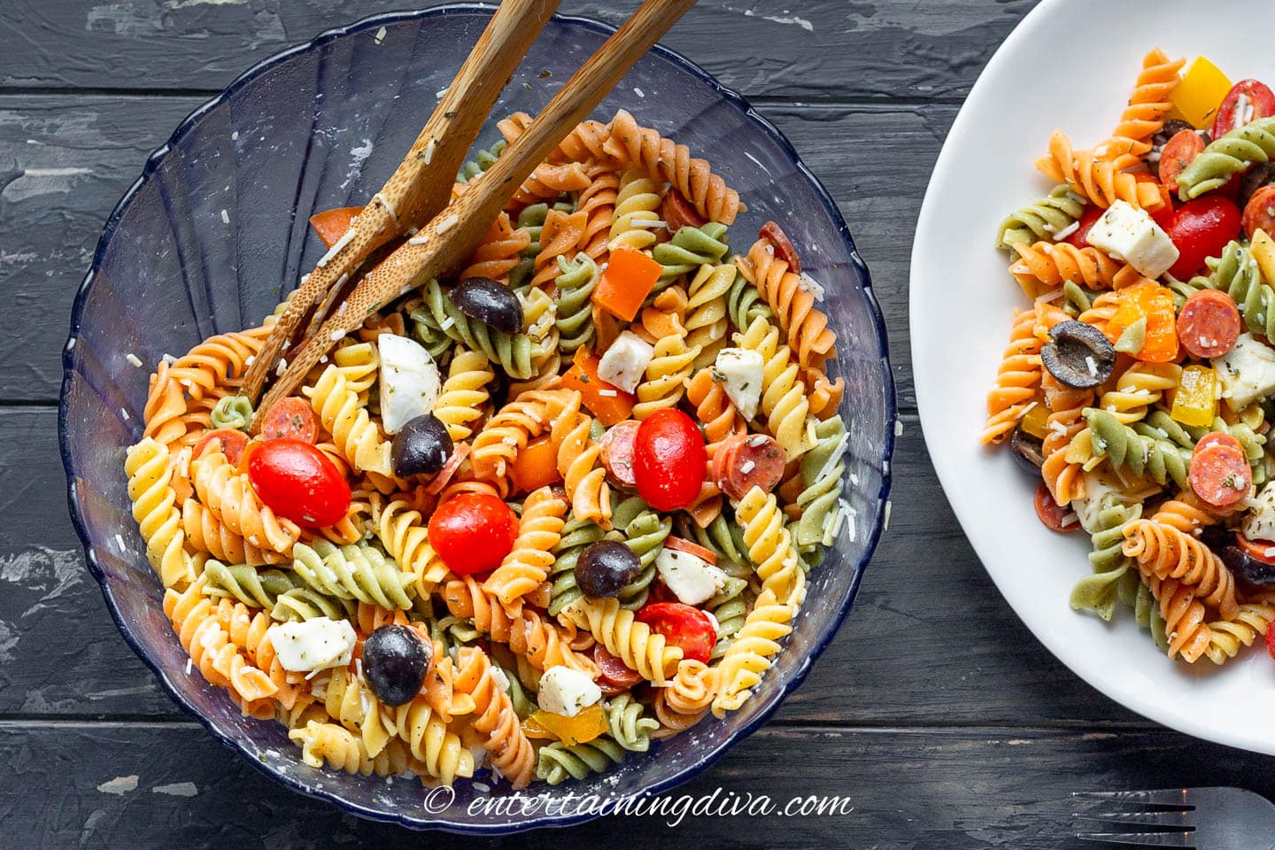 A bowl of Italian pasta salad beside a plate of it