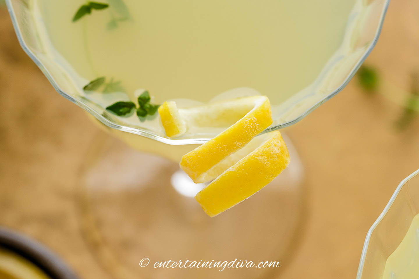 Lemon twist garnish on the side of a glass