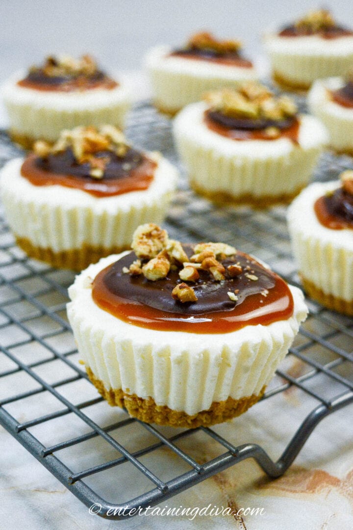 These mini cheesecakes are topped with caramel and pecans.