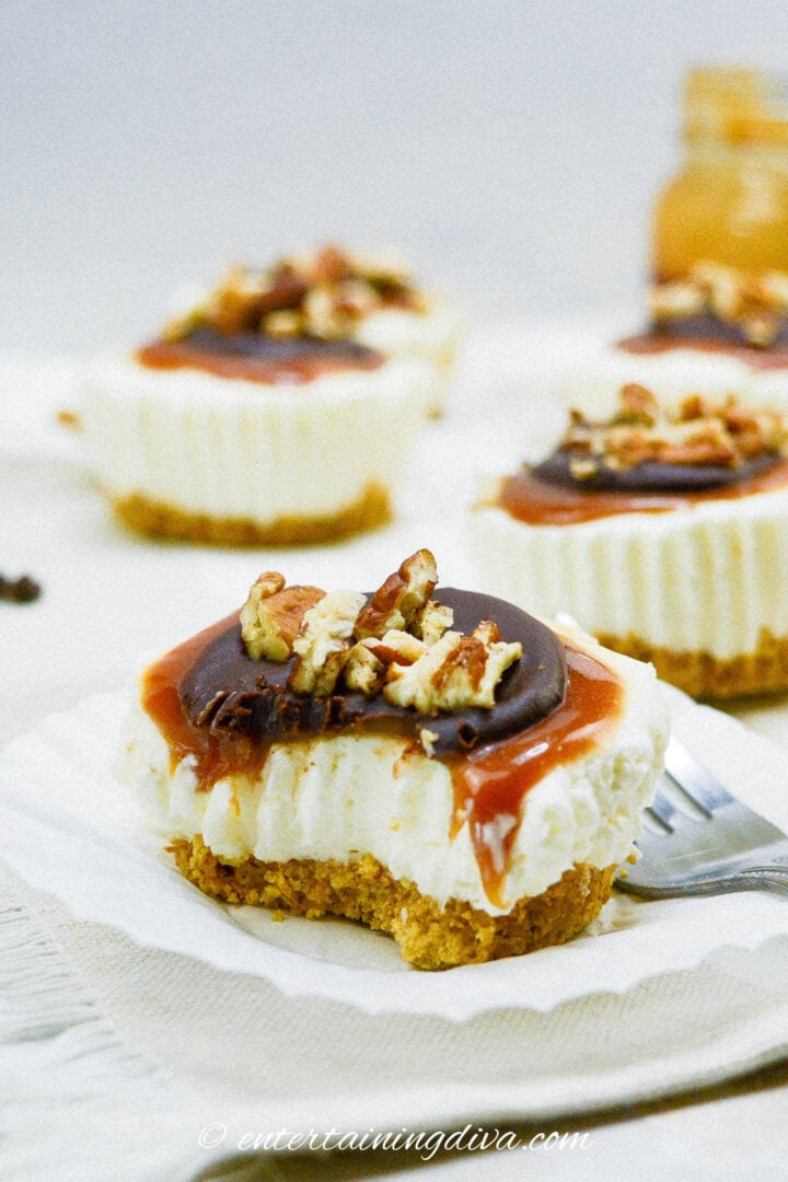 A no bake mini turtle cheesecake with a bite out of it