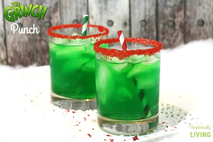 Two glasses of green Grinch punch with red rims.