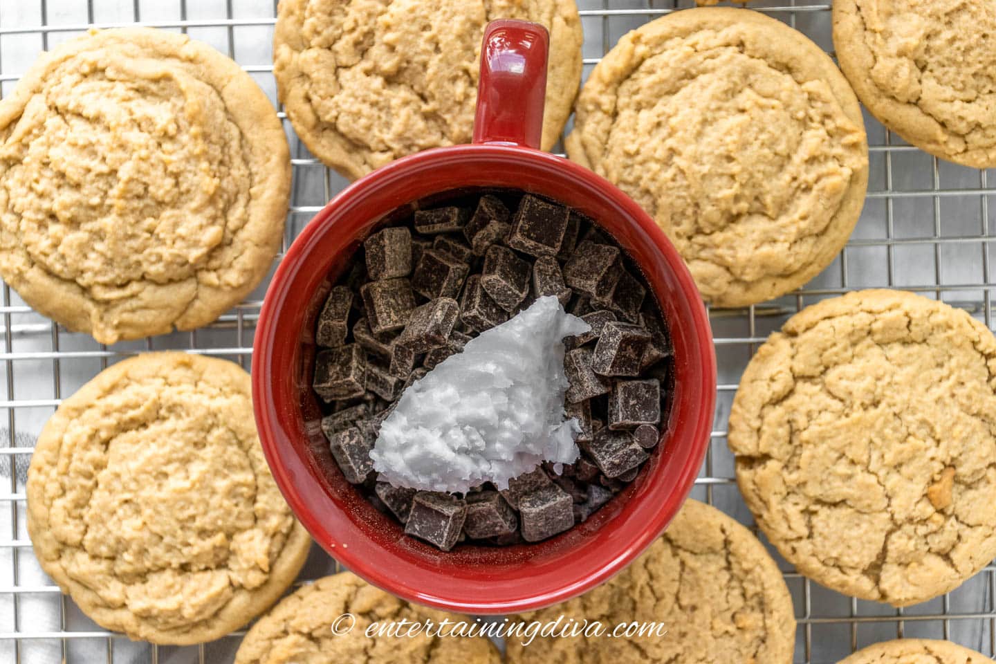 Chocolate and coconut oil in a bowl surrounded by peanut butter cookies