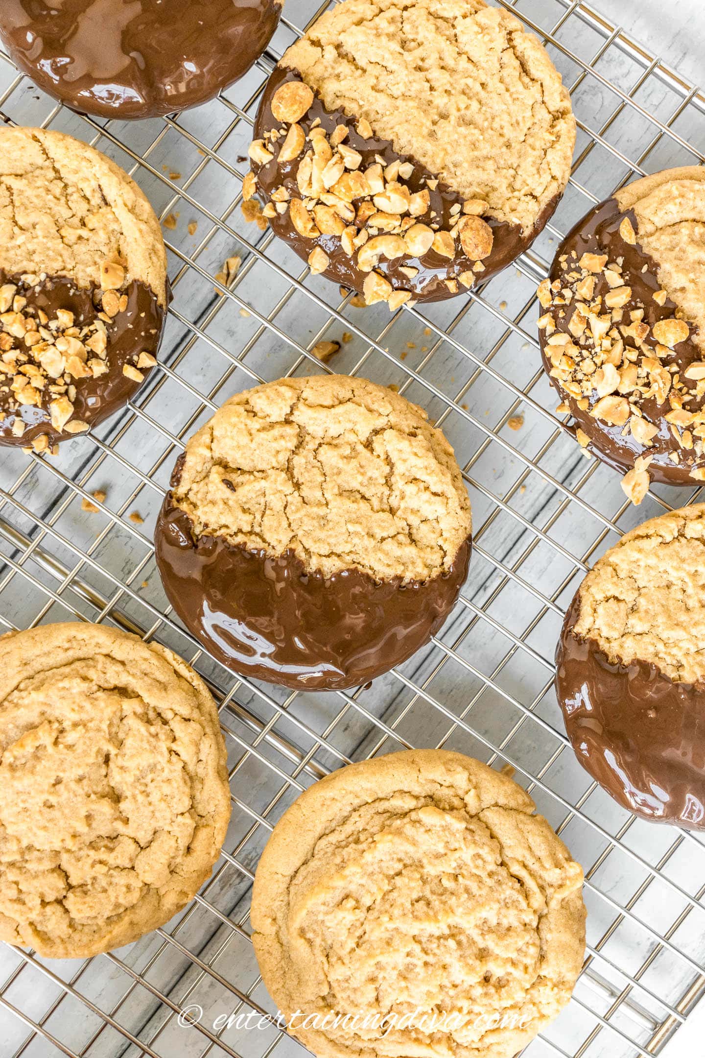 Chocolate dipped peanut butter cookies on a cooling rack.