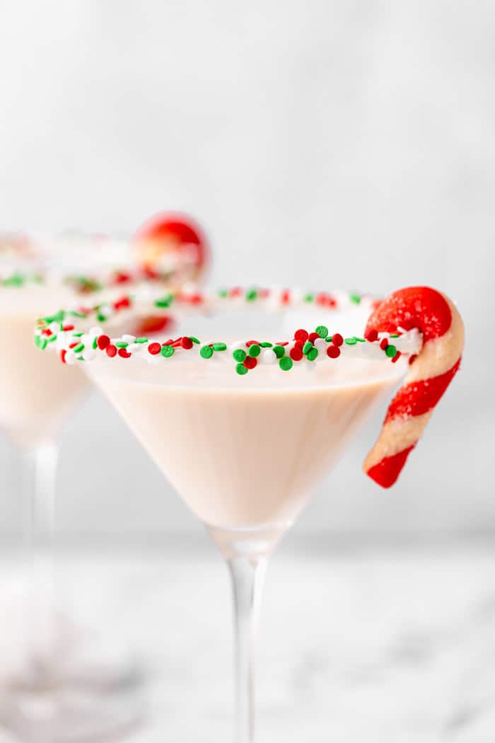 Two sugar cookie martinis with candy cane garnish.