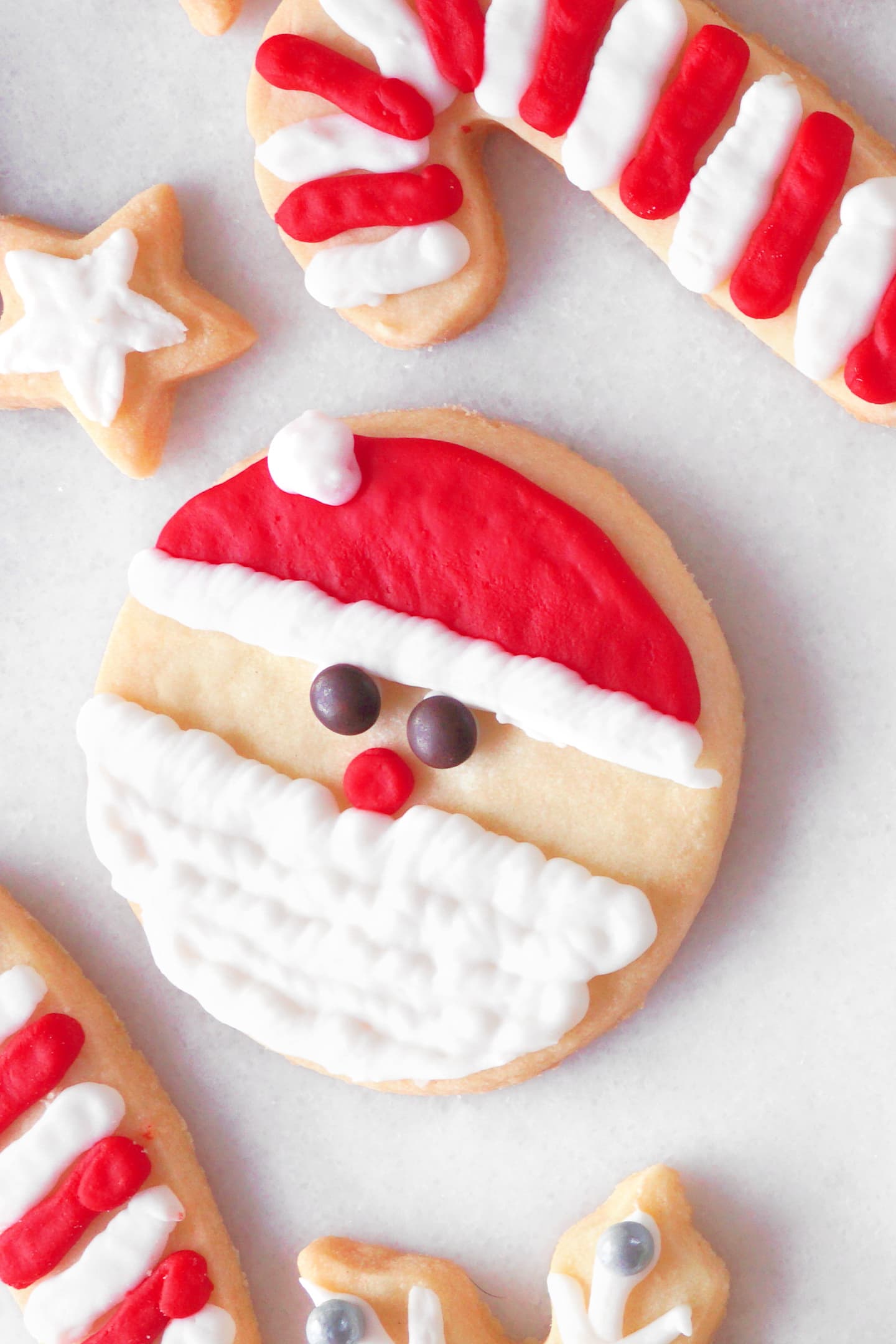 round Christmas sugar cookie decorated to look like Santa