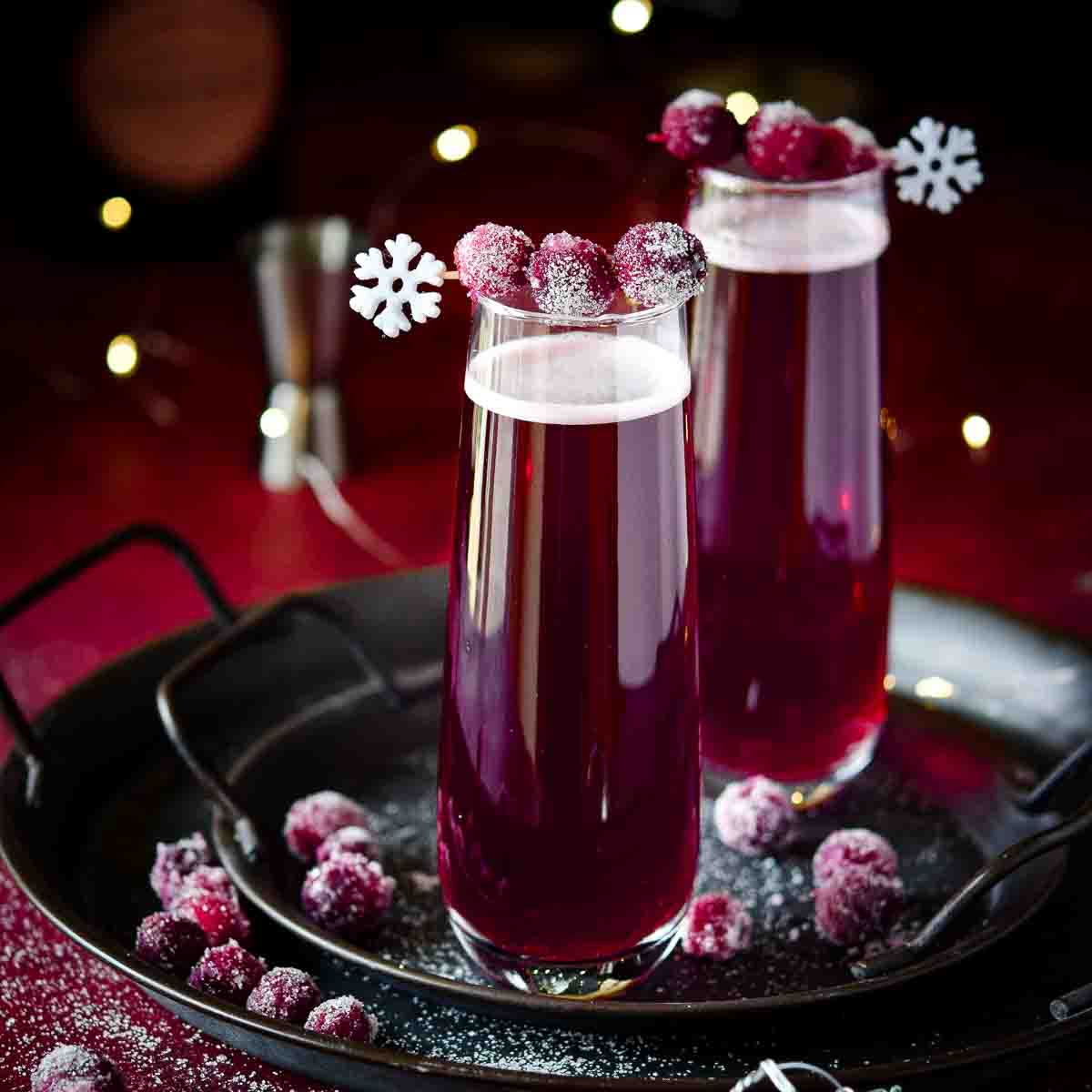 Two glasses of sugared cranberry mimosas
