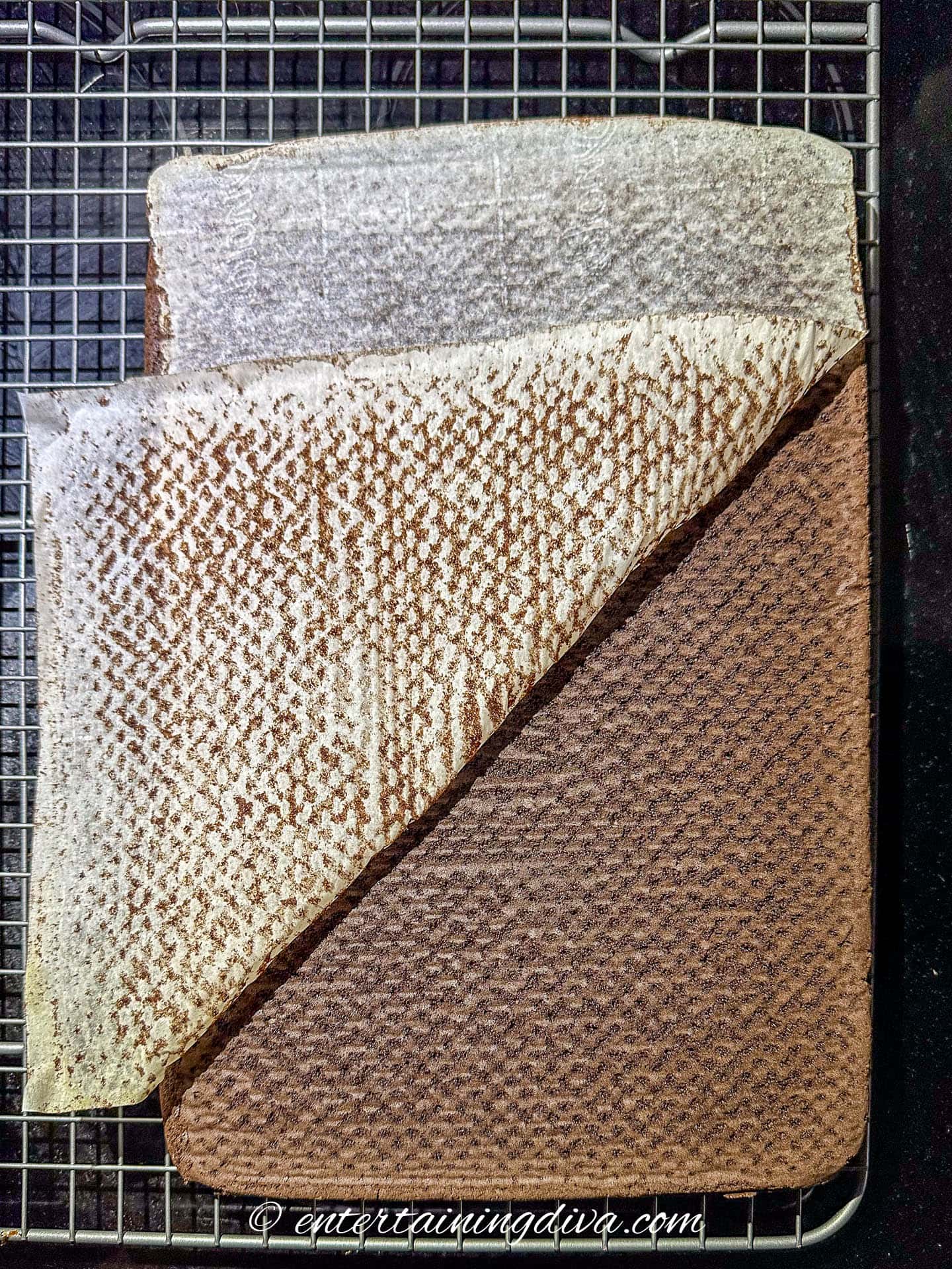 parchment paper being peeled off the bottom of a soda cake