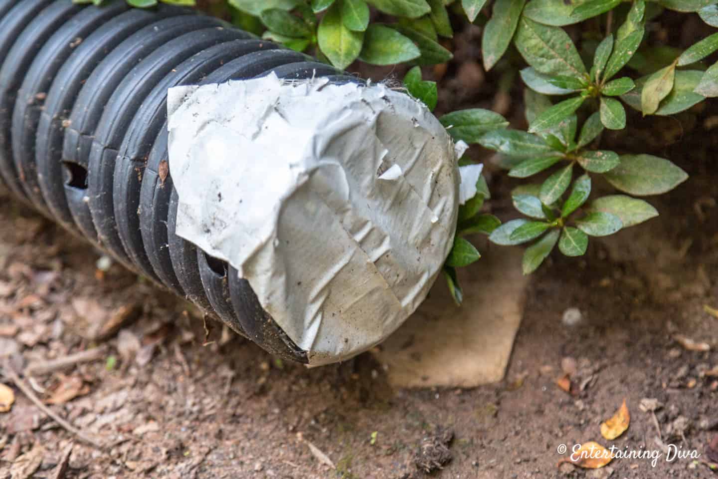 Plastic drainage pipe with duct tape on one end