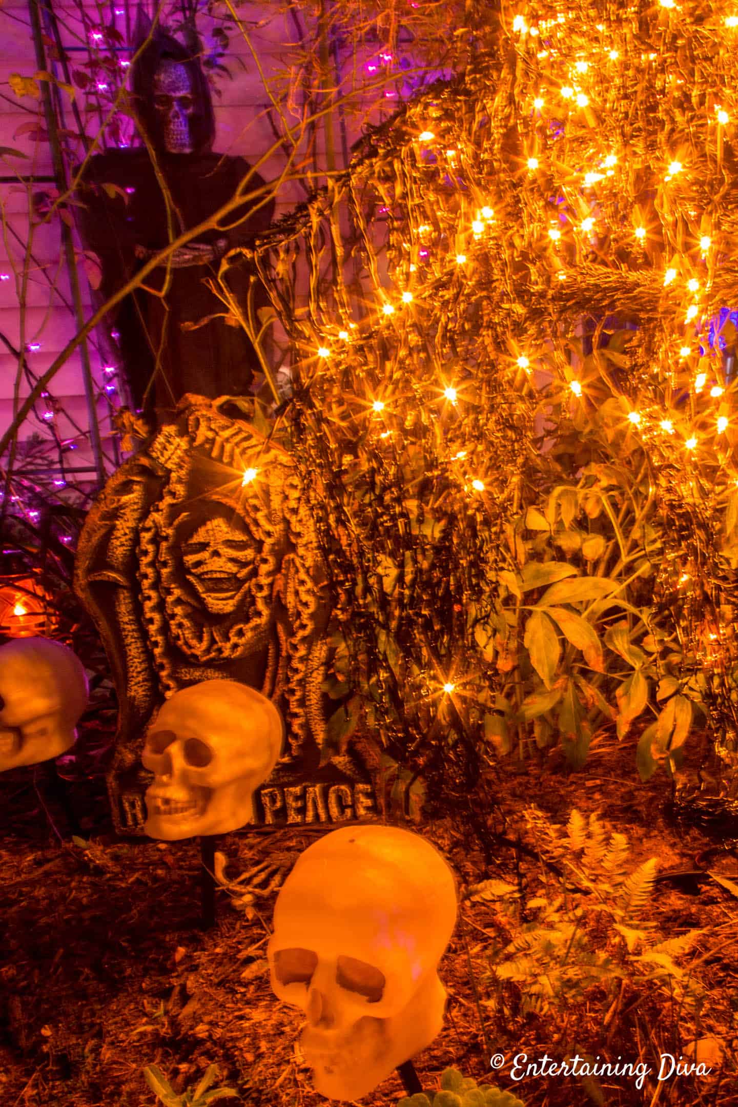 Halloween graveyard with orange lights and skulls