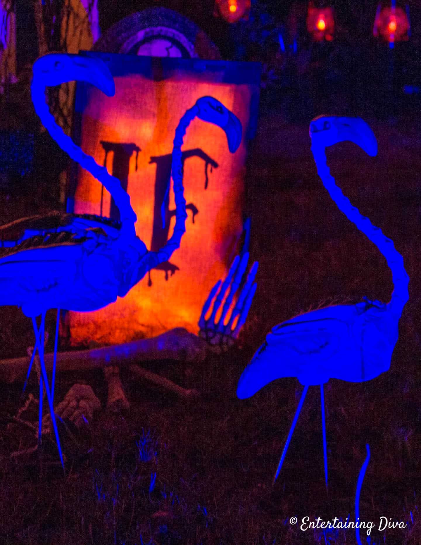Skeleton flamingos in a Halloween graveyard