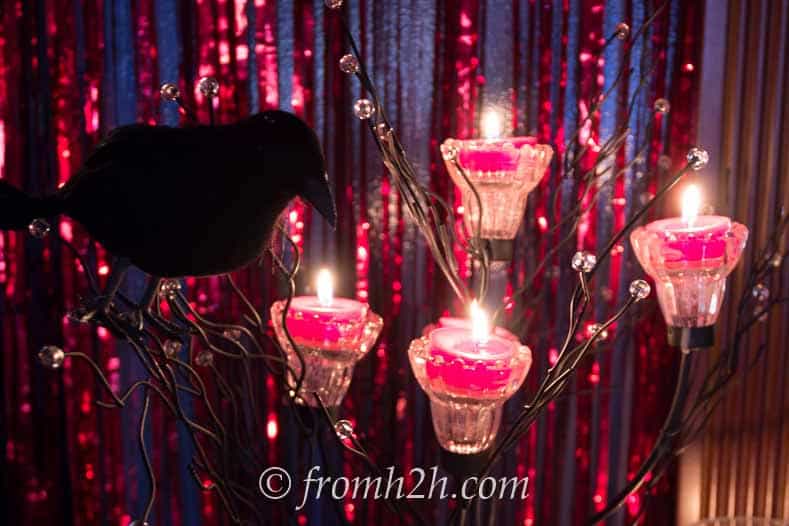 Red foil curtains, red candles and black crows 