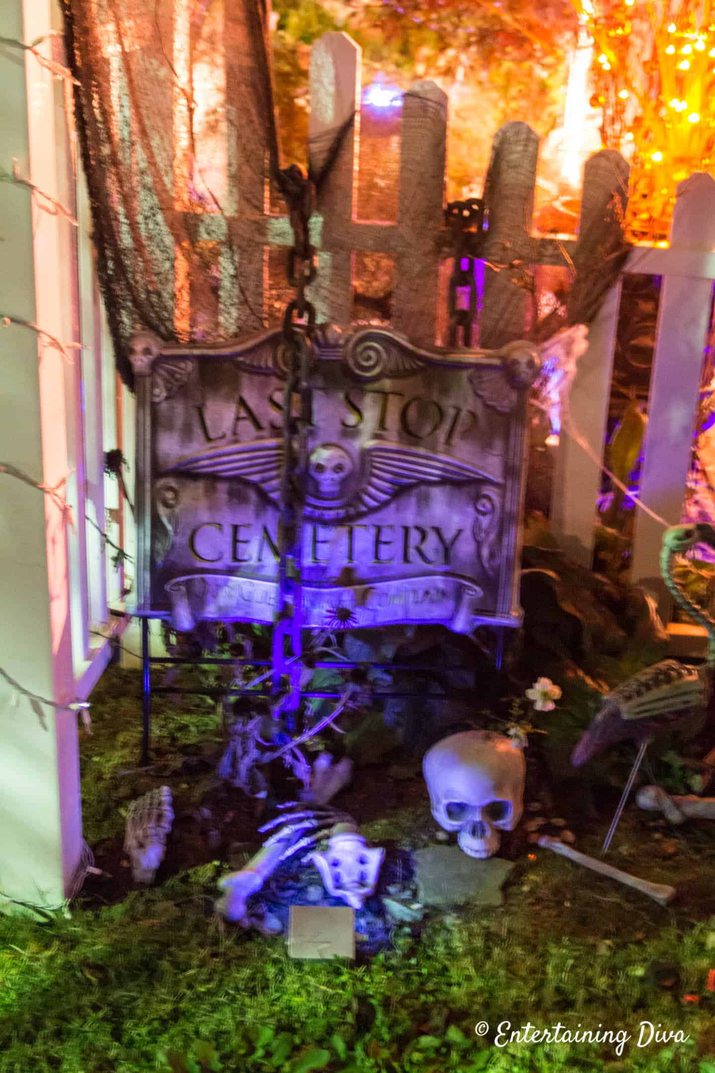Halloween graveyard with chains over a cemetery sign and skeleton bones